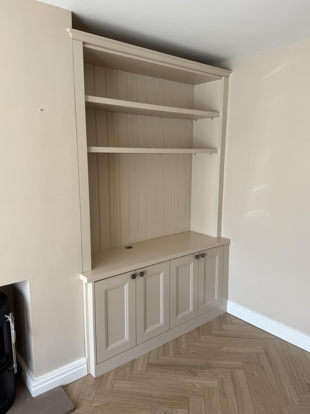 Matching alcove unit with shelves above panelled cupboard doors